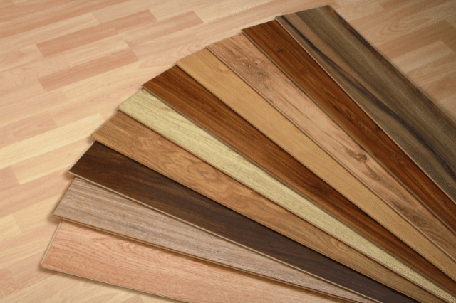 Different colors of hardwood floor planks lined up next to one another