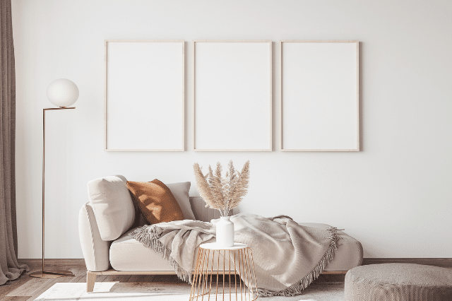 A living room decorated with all neutral paint, decor, and furniture