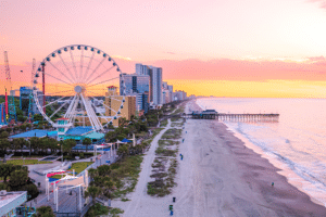 Image of the Myrtle Beach coastline, lined with hotels and the SkyWheel.